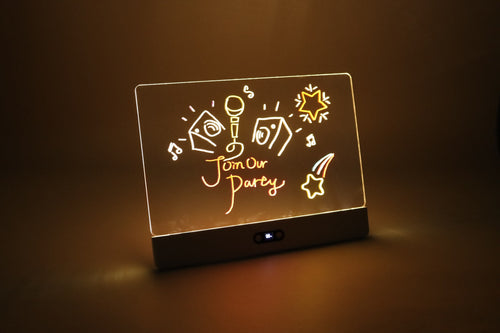 Meshkat Rechargeable RGB LED Drawing Board glowing in a dark room with a colorful hand-drawn party design